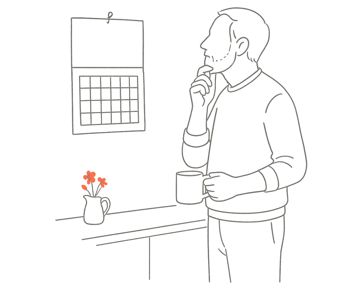 Line drawing of a man with short hair and a beard standing in a kitchen with a mug in one hand and the other at his chin, looking thoughtfully at a calendar hanging on the wall, with a small jug of orange flowers on the worktop